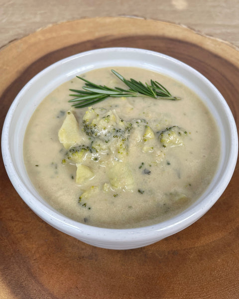 Photo of broccoli cheese soup garnished with rosemary