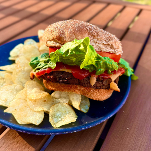 Vegan Burger made with vegan burger Pattie, tomatoes, lettuce and dairy-free cheddar slices 