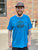 person wearing a blue t shirt with The Herbivorous Butcher logo on it