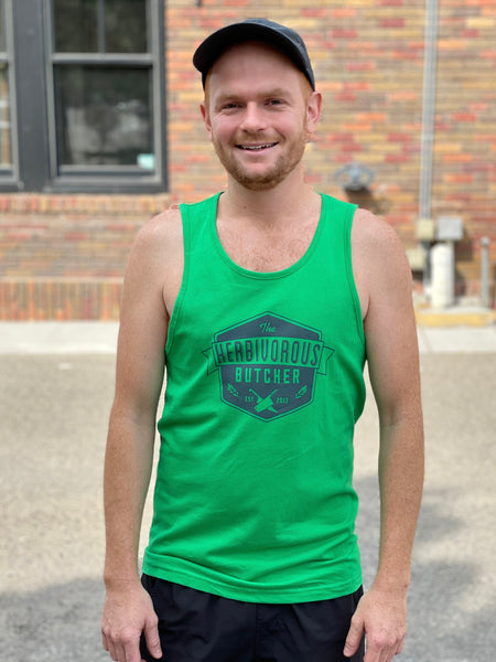 a person wearing a green tank top with The Herbivorous Butcher logo on it