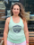 person wearing a light mint green tank top with The Herbivorous Butcher logo on it
