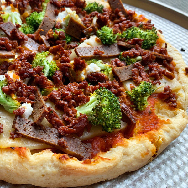 vegan pizza with plant based meats and broccoli