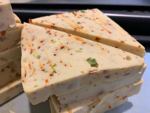 triangular blocks of vegan pepper jack cheese