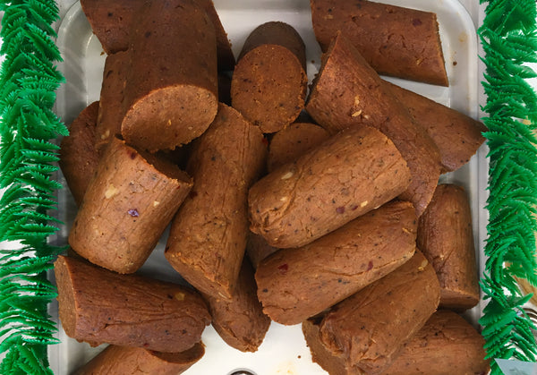 top down shot of small logs of vegan pepperoni