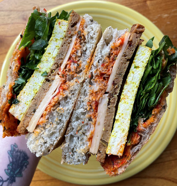 photo of vegan breakfast sandwich  with vegan sausage, vegan egg, and vegan cheese