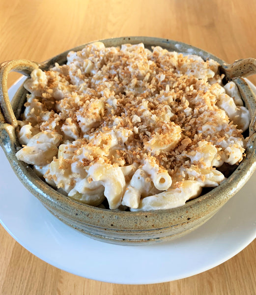 serving dish full of vegan dairy free macaroni and cheese topped with bread crumbs